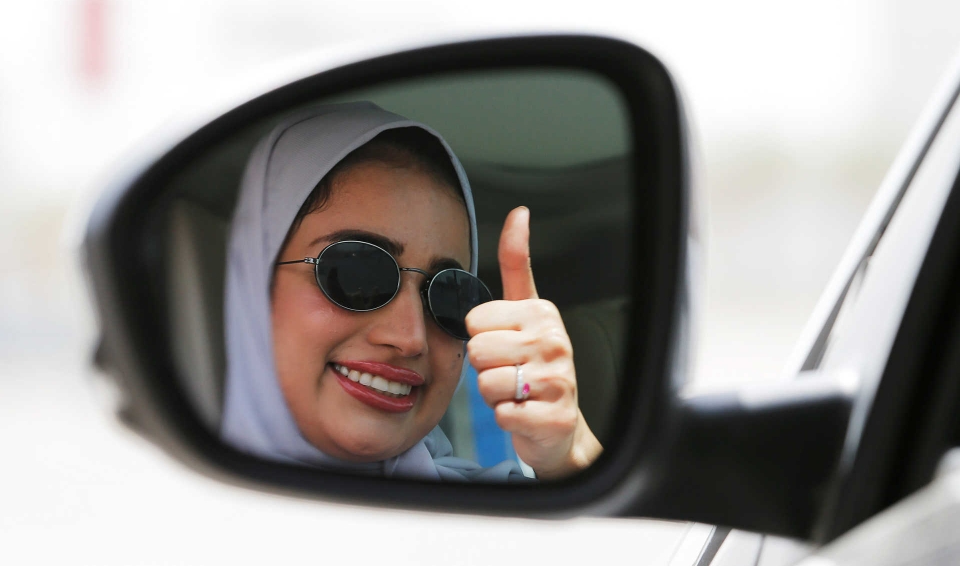 Zuhoor Assiri gestures as she drives her car in Dhahran