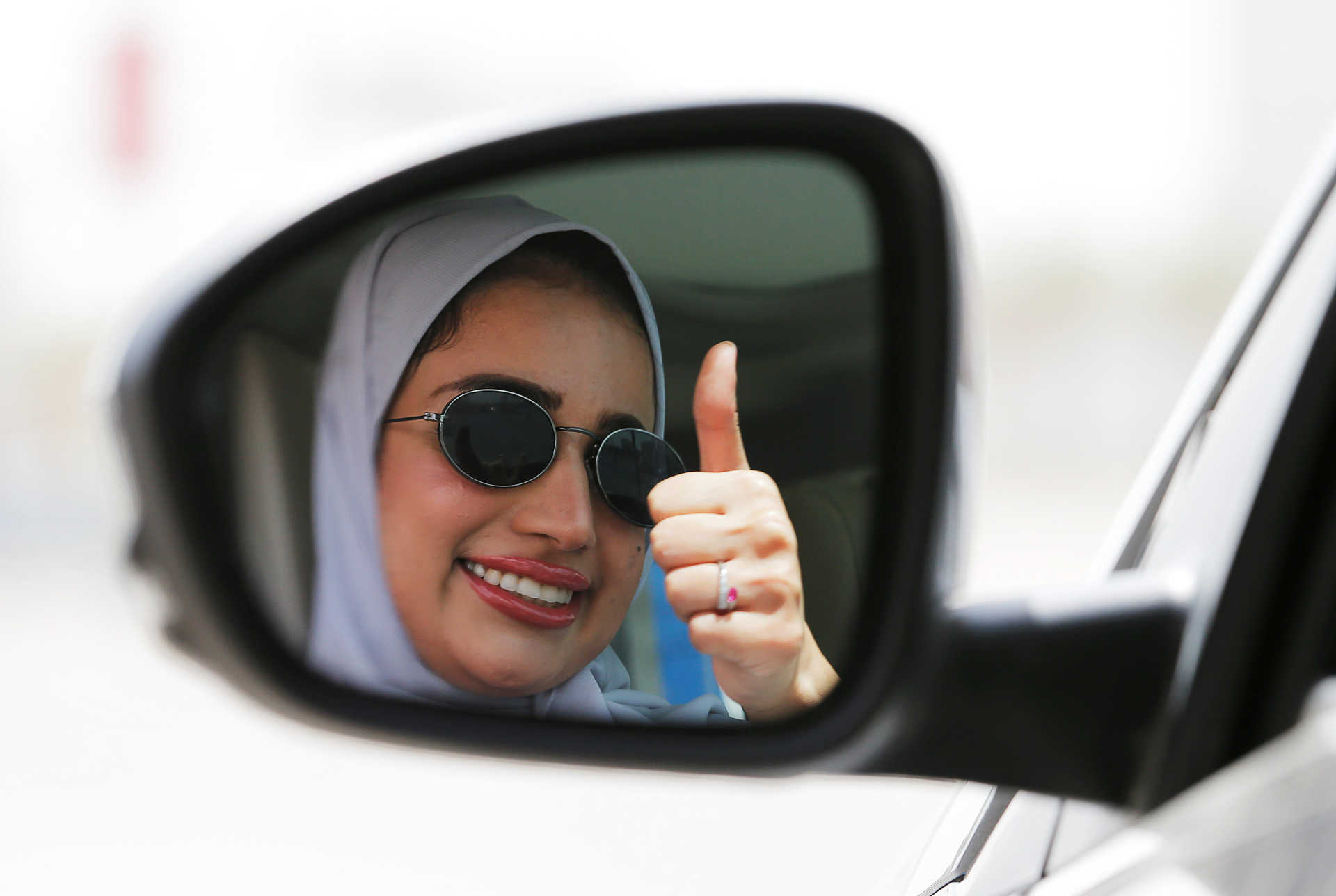 Zuhoor Assiri gestures as she drives her car in Dhahran