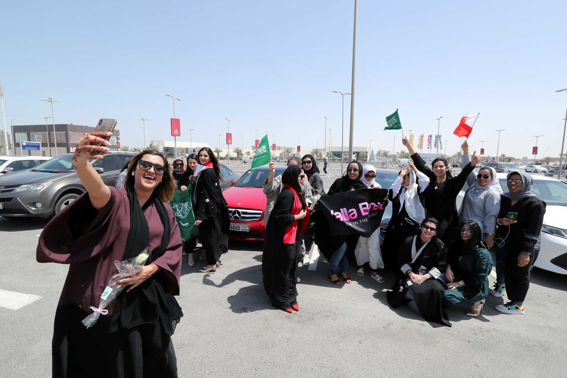 Bahraini woman Eman Mohammed takes a selfie with her phone as she celebrates with Saudi and Bahraini women the lifting of the driving ban on women, in east Saudi Arabia