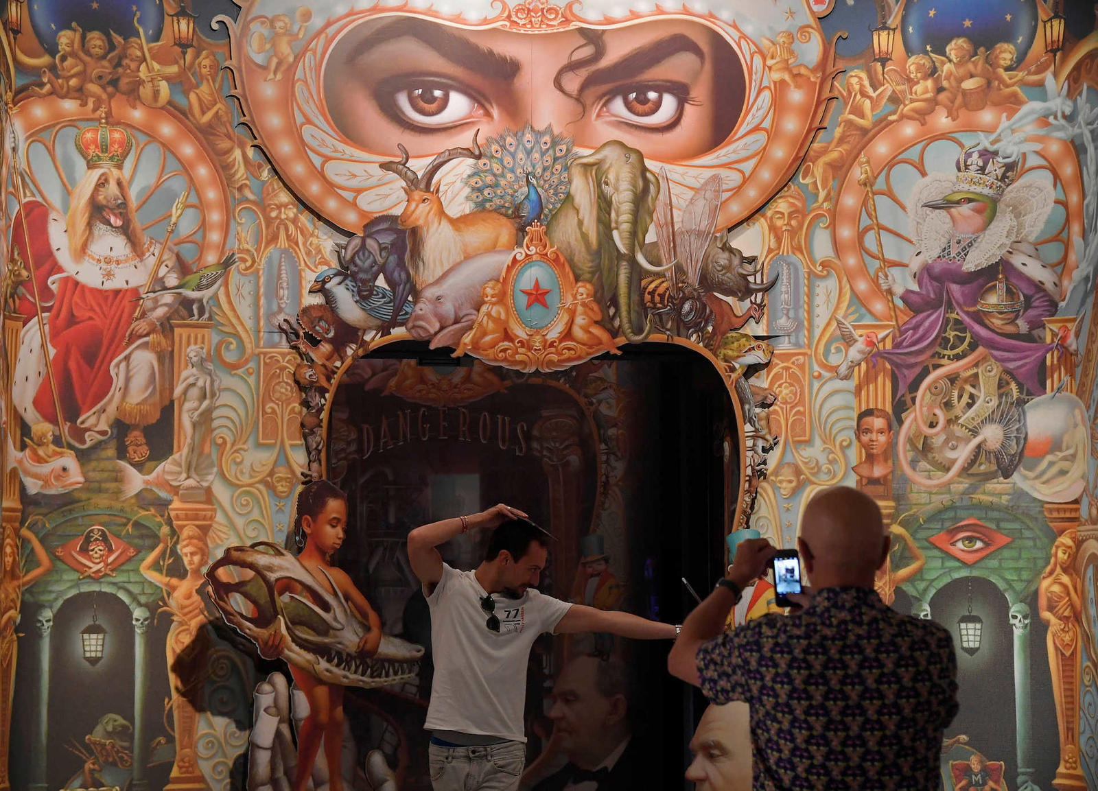 Visitors take photos beside ‘Detail of the King of Pop’ by Mark Ryden which forms part of the exhibition ‘Michael Jackson: On The Wall’ at the National Portrait Gallery in London, Britain